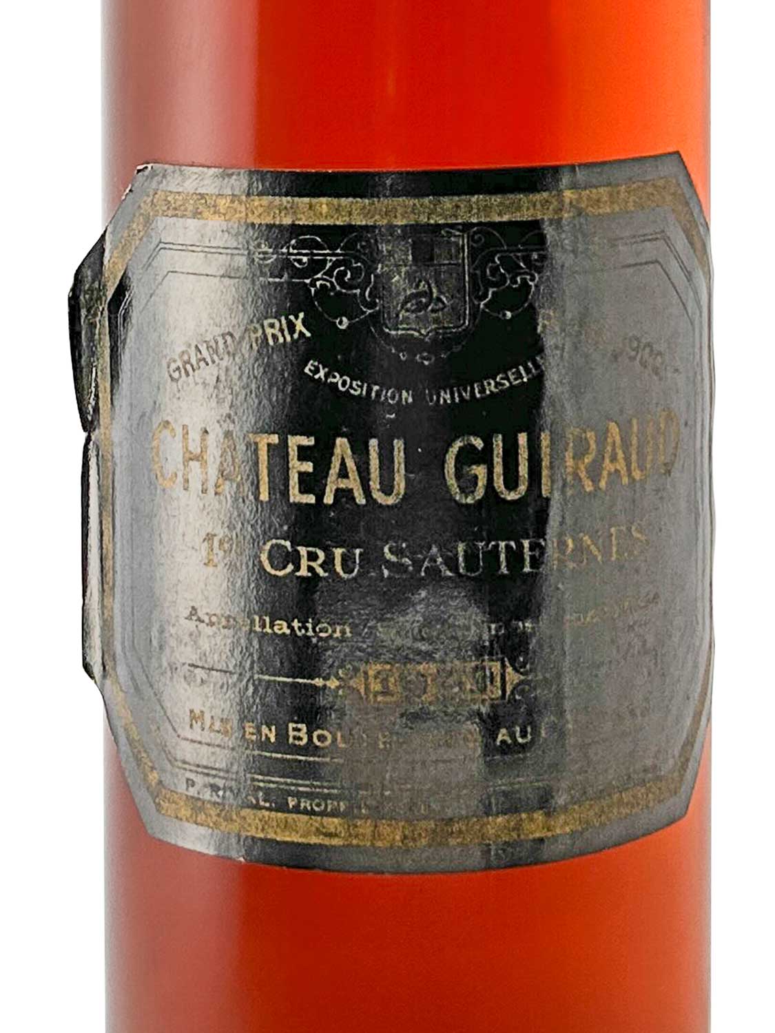 Flasche Château Guiraud Dessertwein mit altem, abgenutztem Etikett in Schwarz und Gold, Text 'CHATEAU GUIRAUD 1er CRU SAUTERNES' sichtbar.