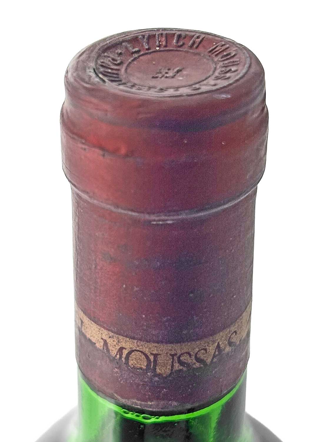 Flaschenhals einer grünen Weinflasche mit rotem Kapselverschluss und teilweise sichtbarem Etikett mit der Aufschrift 'MOUSSAS'