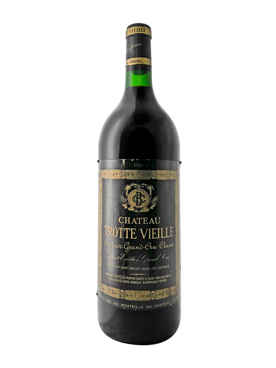 Dunkelgrüne Weinflasche mit schwarzem Etikett und goldener Schrift 'Chateau Trotte Vieille Premier Grand-Cru Classé 1986'.